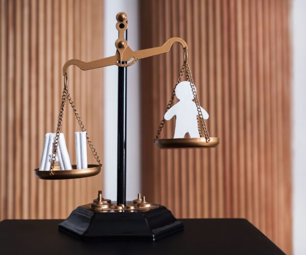balance-scales-showing-the-weight-of-one-person-2026-03-24-04-50-43-utc (1)